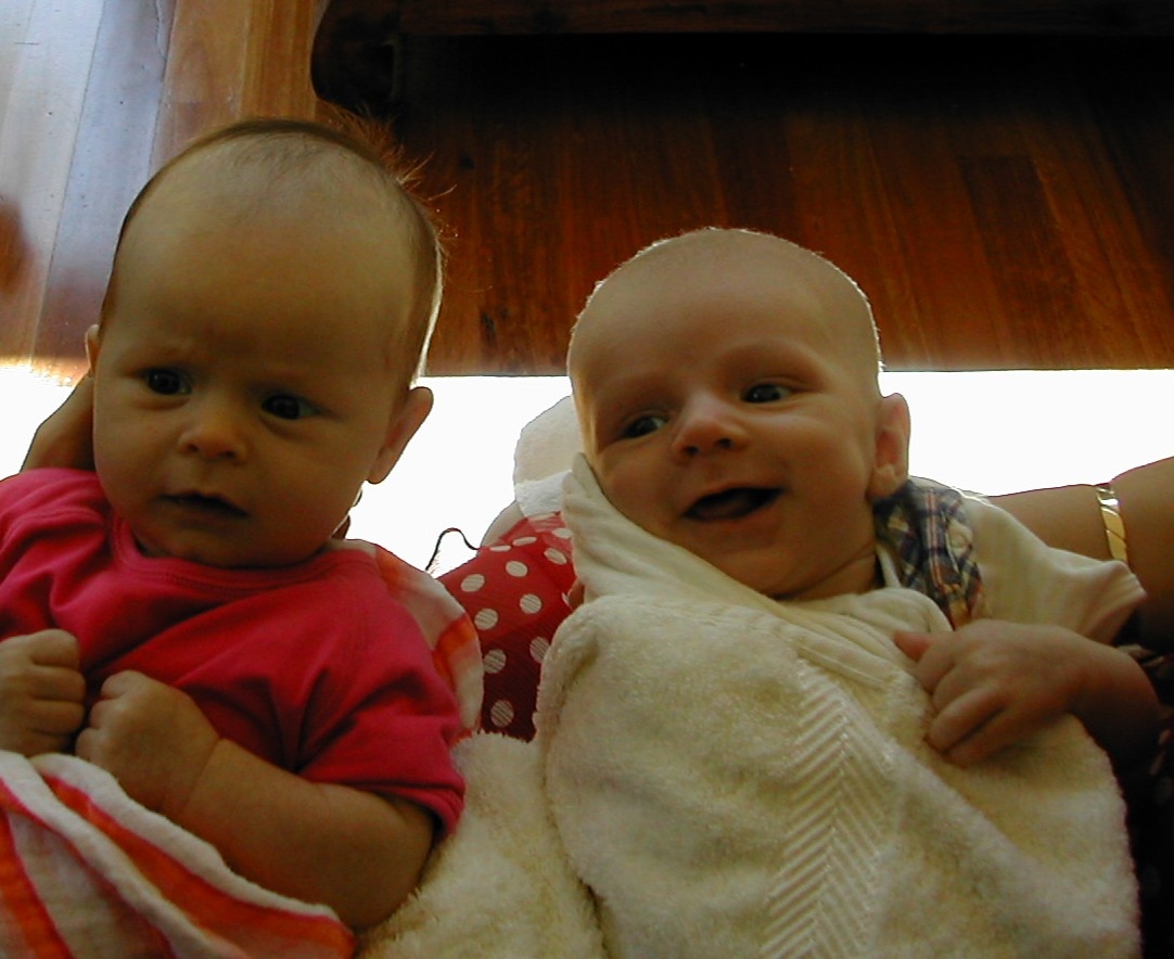 Two babies. One smiling.